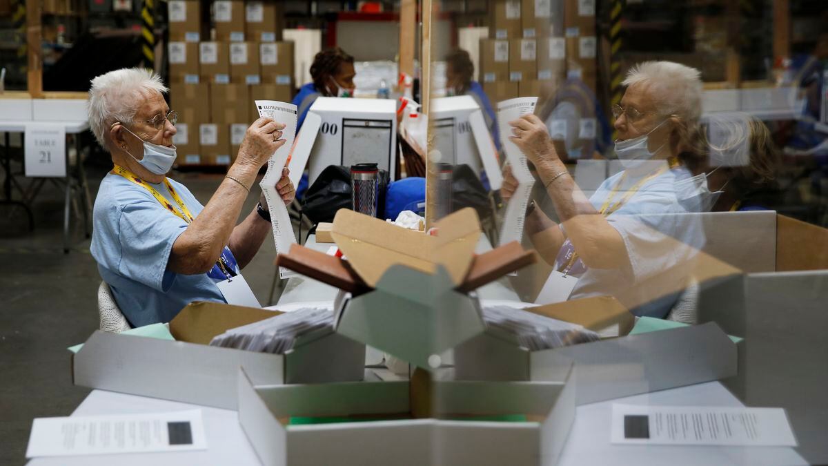 FILE - In this June 9, 2020, file photo, election workers process mail-in ballots during a...