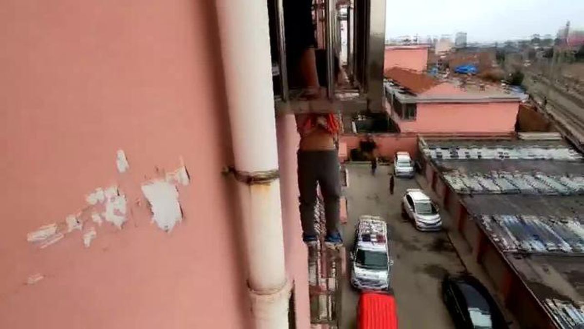 Firefighters in China rescued a 4-year-old boy whose head became stuck in a window's guard rail, leaving him hanging four stories above ground.(Source: CCTV/CNN)