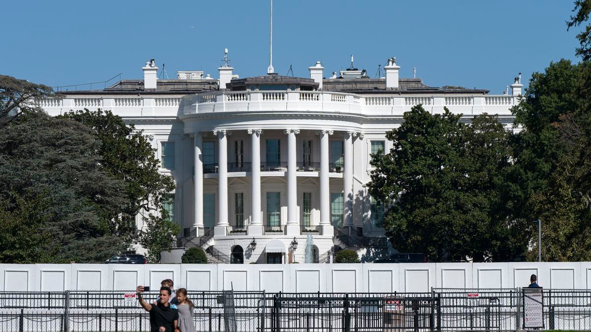 A family takes group portrait, Thursday, Oct. 8, 2020, outside of the White House in Washington.